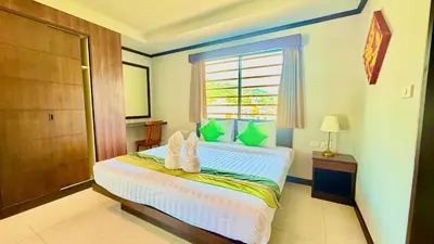 a bedroom with a bed with towels on it at KS Residence Patong in Patong Beach