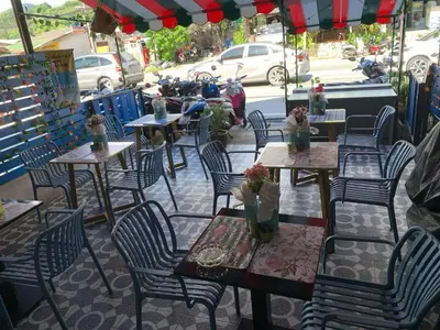 a group of tables and chairs on a patio at Ciao Bella GuestHouse & Bistro in Kata Beach