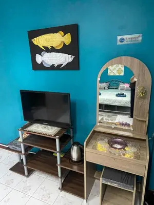 a room with a desk and a computer on a table at Ciao Bella GuestHouse & Bistro in Kata Beach