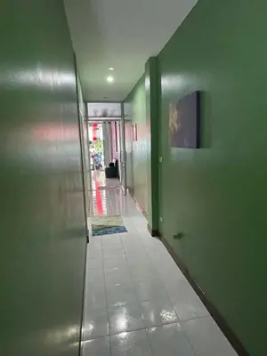 an empty hallway with green walls and a hallway with at Ciao Bella GuestHouse & Bistro in Kata Beach