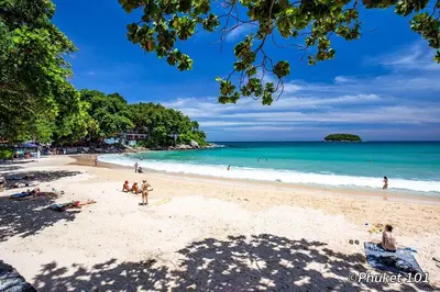 a group of people on a beach with the ocean at Ciao Bella GuestHouse & Bistro in Kata Beach