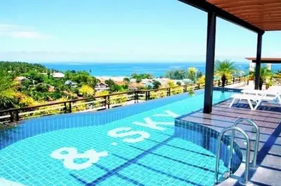 a swimming pool with a view of the ocean at Сhic condo студия с бассейном in Karon Beach