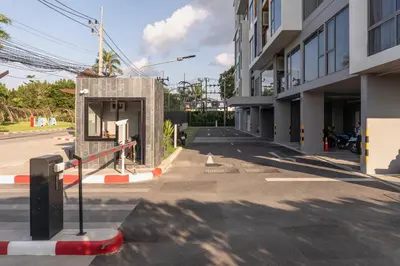 an empty street next to a tall building at Laguna Lakeside Apartment Phuket Bang Tao in Bang Tao Beach