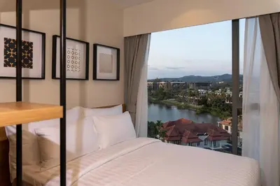 a bedroom with a bed with a view of a river at Laguna Lakeside Apartment Phuket Bang Tao in Bang Tao Beach