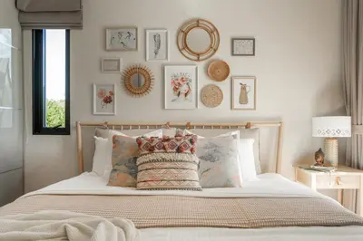 a bedroom with a bed with a bunch of pictures on the wall at Title Halo Wild Spirit Naiyang Pool Gym 2BR in Nai Yang Beach