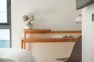 a bedroom with a wooden shelf with a vase on it at Title Halo Wild Spirit Naiyang Pool Gym 2BR in Nai Yang Beach