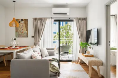 a living room with a couch and a table at Title Halo Wild Spirit Naiyang Pool Gym 2BR in Nai Yang Beach