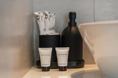 a bottle of wine and two cups on a counter at Title Halo Wild Spirit Naiyang Pool Gym 2BR in Nai Yang Beach
