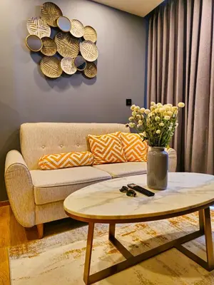 a living room with a couch and a coffee table at Family Luxe Apartment in 5 Star hotel in Phuket Town