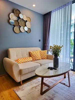 a living room with a couch and a table at Family Luxe Apartment in 5 Star hotel in Phuket Town