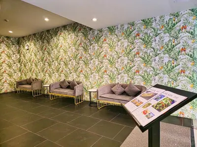 a room with two couches and a wall mural at Family Luxe Apartment in 5 Star hotel in Phuket Town