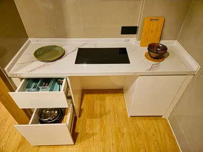 a small kitchen with a counter top and a stove at Family Luxe Apartment in 5 Star hotel in Phuket Town