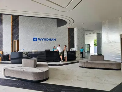 a lobby with people standing in a building at Family Luxe Apartment in 5 Star hotel in Phuket Town