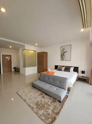 a large bedroom with a bed and a couch at Chic condominium karon beach in Karon Beach