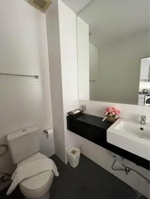 a bathroom with a white toilet and a sink at Chic condominium karon beach in Karon Beach