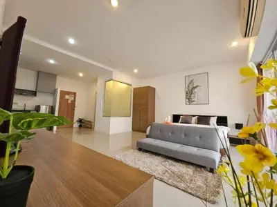a living room with a couch and a table at Chic condominium karon beach in Karon Beach