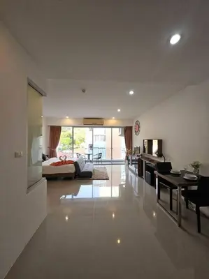 a large living room with a bed and a table at Chic condominium karon beach in Karon Beach