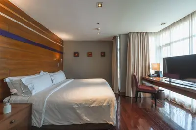 a bedroom with a bed and a desk and a television at Angsana Laguna Phuket, family suite villa duplex, private unit with hotel kids club, pools and beach access in Laguna Phuket