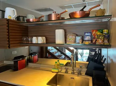 a kitchen with a sink and some pots and pans at Angsana Laguna Phuket, family suite villa duplex, private unit with hotel kids club, pools and beach access in Laguna Phuket