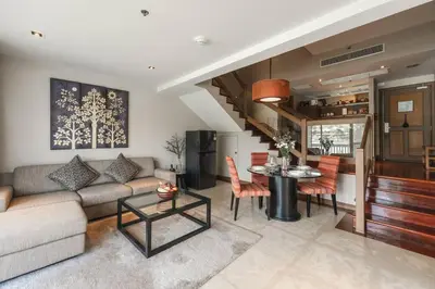 a living room with a couch and a table at Angsana Laguna Phuket, family suite villa duplex, private unit with hotel kids club, pools and beach access in Laguna Phuket
