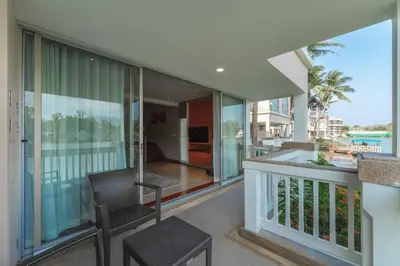 a balcony of a house with two chairs at Angsana Laguna Phuket, family suite villa duplex, private unit with hotel kids club, pools and beach access in Laguna Phuket