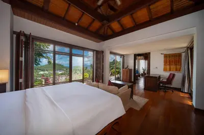 a bedroom with a large white bed and a large window at surin Luxurious 6br private swimming pool stunning sunset in Phuket Town