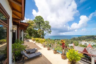 a balcony with chairs and a view of the ocean at surin Luxurious 6br private swimming pool stunning sunset in Phuket Town