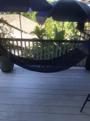 a hammock on a porch with an umbrella at Cancel in Phang-nga