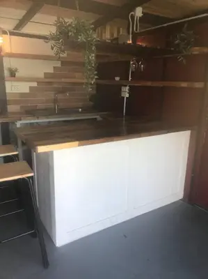 a kitchen with a white counter top and wooden walls at Cancel in Phang-nga