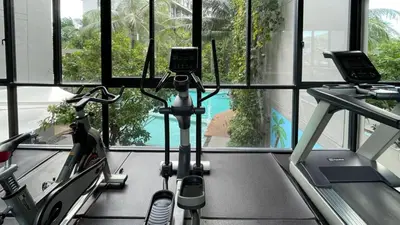 a gym with two exercise bikes in front of a window at Cozy apartment with a Resort Facilities in Bangtao in Bang Tao Beach