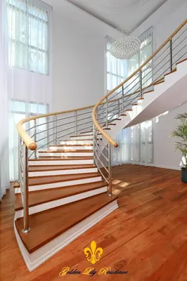 a metal staircase in a room with wooden floors at Golden Lily 4 Bedroom Private Pool Villa in Rawai Beach