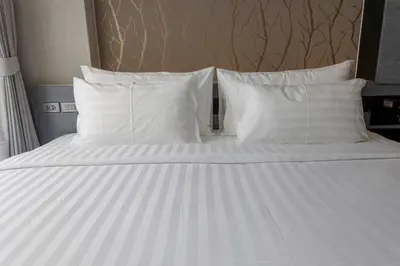 a white bed with white pillows on it at 600m to beach New City gate P214 #c60 in Kamala Beach