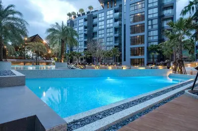 a large blue swimming pool with buildings in the background at 600m to beach New City gate P214 #c60 in Kamala Beach