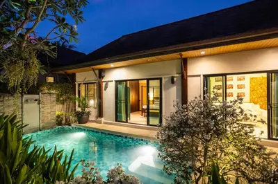 a house with a swimming pool in front of it at Most Beautiful Relaxation Garden Villa V86 in Rawai Beach