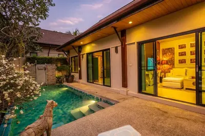 a house with a swimming pool in front of it at Most Beautiful Relaxation Garden Villa V86 in Rawai Beach