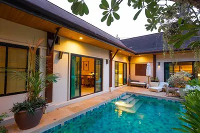 a house with a swimming pool next to a house at Most Beautiful Relaxation Garden Villa V86 in Rawai Beach