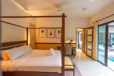 a bedroom with a large bed and a dining room at Most Beautiful Relaxation Garden Villa V86 in Rawai Beach