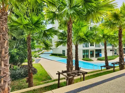 a resort with palm trees and a swimming pool at 2 BDR Suite in 5 Star Hotel in Rawai Beach