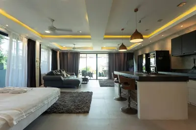a kitchen and living room with a bed in a room at 4 Big Separate Apartments SeaView 8KingBeds v104 in Karon Beach
