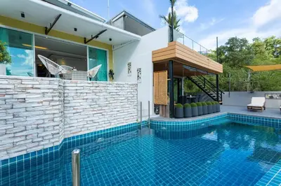 a swimming pool in front of a house at 4 Big Separate Apartments SeaView 8KingBeds v104 in Karon Beach