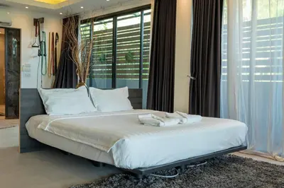 a bedroom with a large bed with towels on it at 4 Big Separate Apartments SeaView 8KingBeds v104 in Karon Beach