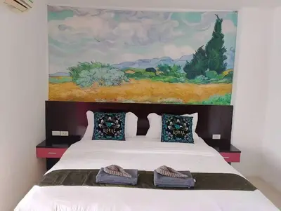 a bedroom with a bed with two slippers on it at sun flower \u4e00\u5367\u7cbe\u54c1\u5927\u5e8a\u623f in Patong Beach