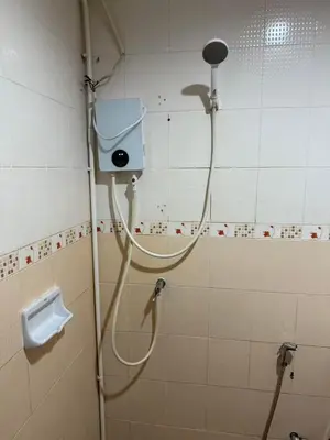a shower in a bathroom with a shower head at sun flower \u4e00\u5367\u7cbe\u54c1\u5927\u5e8a\u623f in Patong Beach