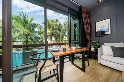 a living room with a table and a couch at Saturdays by Lotus Heart in Ban Saiyuan (1)