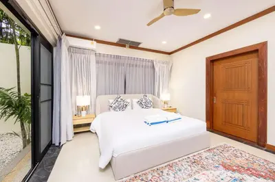 a bedroom with a white bed and a window at Meraya Villa with Private Pool Near Nai Harn Beach in Rawai Beach