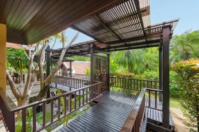 a wooden walkway to the front porch of a house at Meraya Villa with Private Pool Near Nai Harn Beach in Rawai Beach