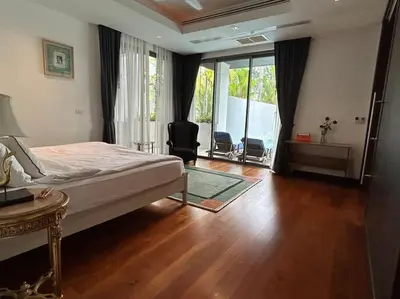 a bedroom with a bed and a desk and a window at A lovely 2-3 bed only 300m walk to Bangtao Beach in Phuket