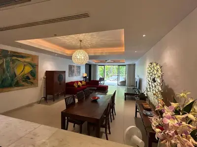 a living room with a table and a couch at A lovely 2-3 bed only 300m walk to Bangtao Beach in Phuket