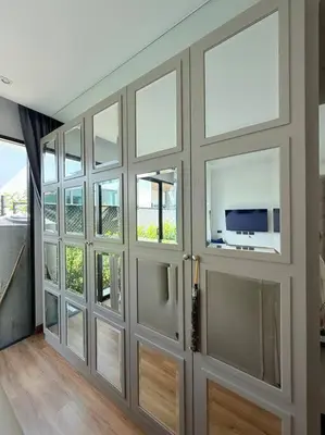a room with doors with windows and a television at Вилла 2 санузла, 2 спальни in Ban Suan
