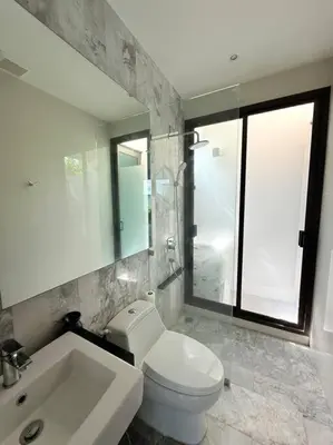 a bathroom with a white toilet and a sink at Вилла 2 санузла, 2 спальни in Ban Suan